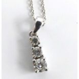 An 18ct white gold diamond three-stone pendant, having graduated round brilliant cut diamonds in