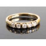 A 9ct gold diamond half eternity ring arranged as five bezel set round brilliants, total diamond