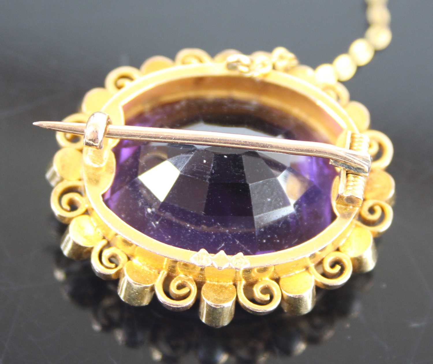 A yellow metal, amethyst and pearl oval cluster brooch, featuring a centre oval amethyst bezel set - Image 2 of 4