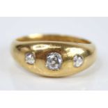 A gent's 18ct gold diamond three-stone ring, the flush set graduated old cushion cuts total weight