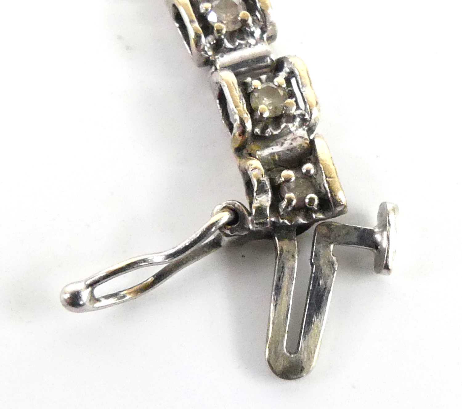 A 9ct white gold diamond tennis style bracelet, having box clasp and figure-of-eight safety catch, - Image 5 of 5