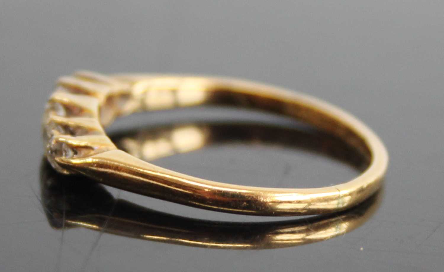 An 18ct gold and platinum diamond half hoop ring, arranged as five claw set graduated round cuts, - Image 5 of 7