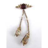 An Edwardian yellow metal multi-stone bar brooch, featuring an octagonal garnet within a foliate