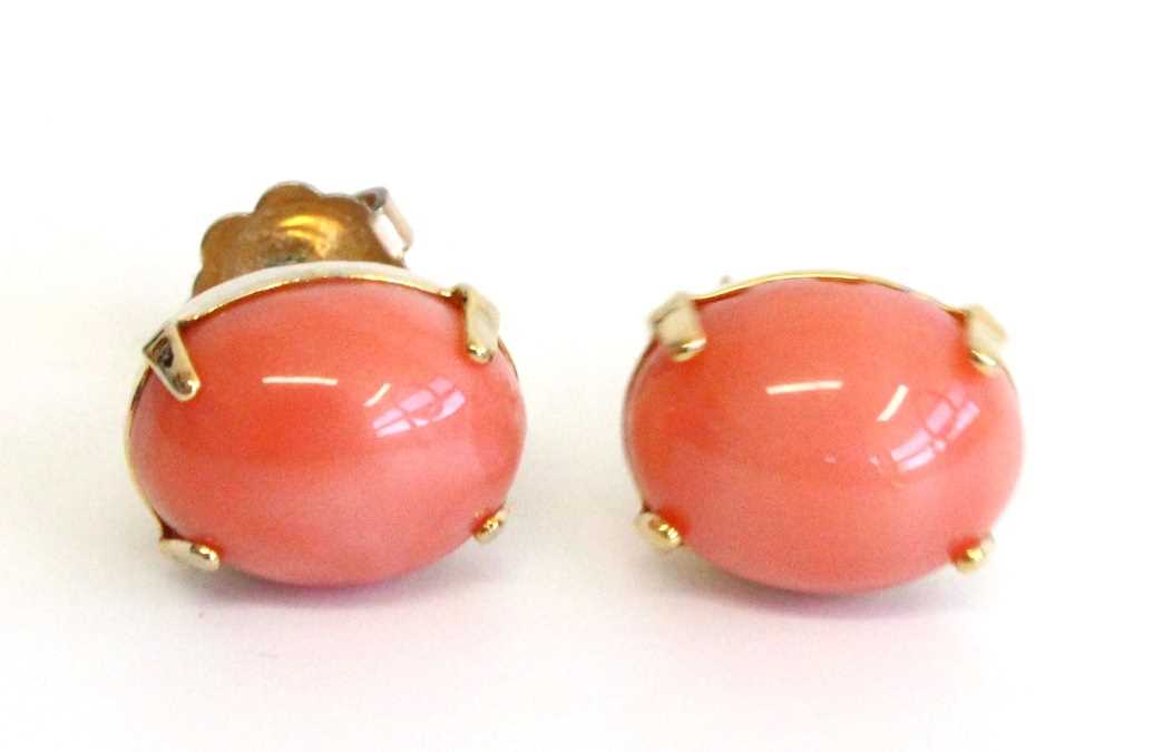 A pair of Hawaiian yellow metal and coral set ear studs, stamped 12k and tested as approx 12ct gold,