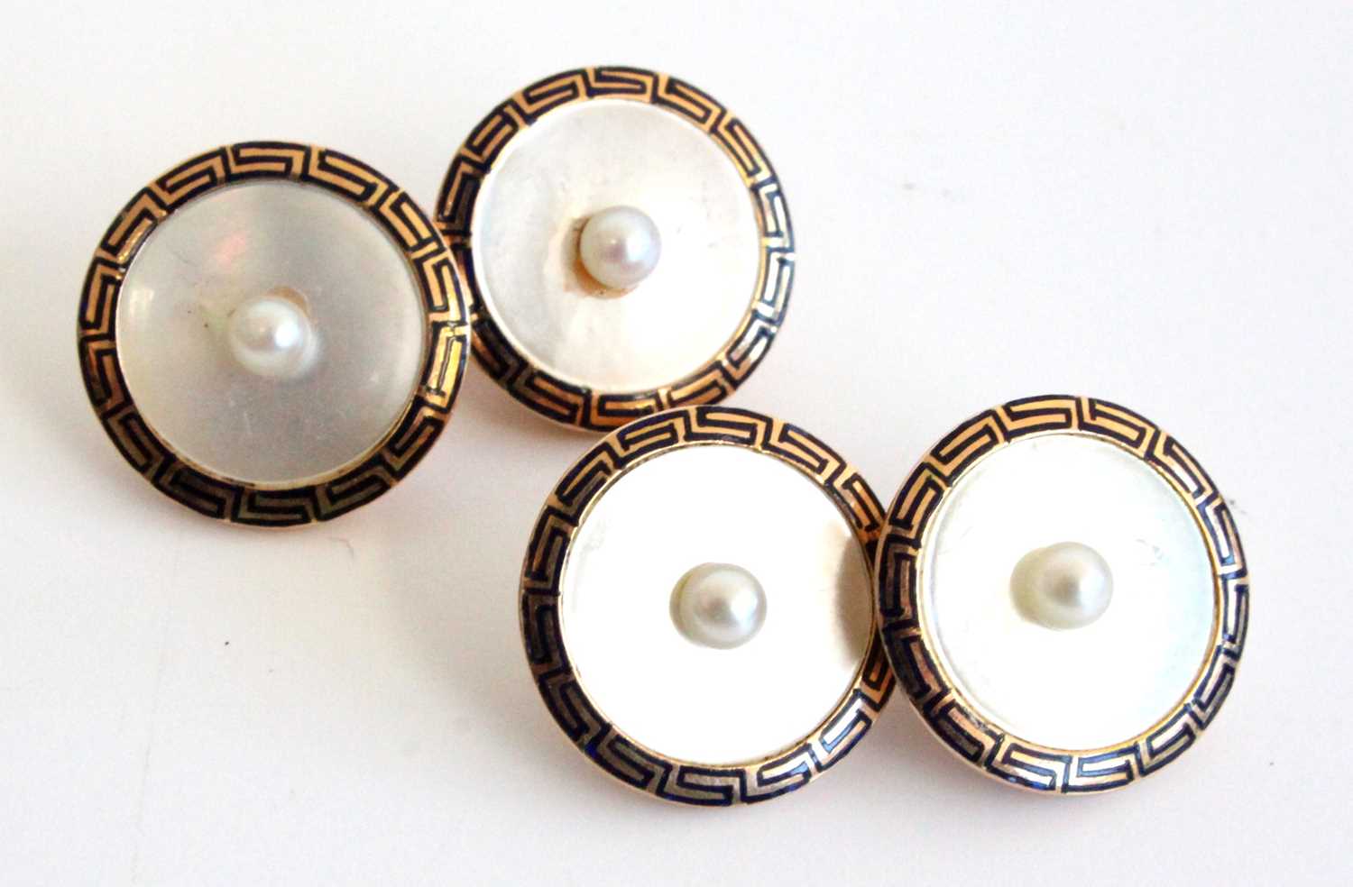 A cased pair of Mappin & Webb yellow metal, mother of pearl and seed pearl set gent's cufflinks,