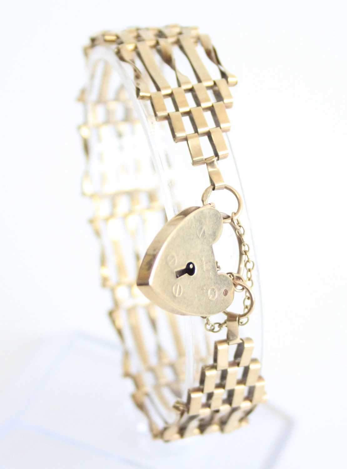 A 9ct gold gatelink bracelet, with heart shaped padlock clasp and safety chain, 10.8g, length 17cm