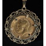 A George V gold half sovereign, 1914, in 9ct gold mount and on 9ct gold flat curblink neck chain,