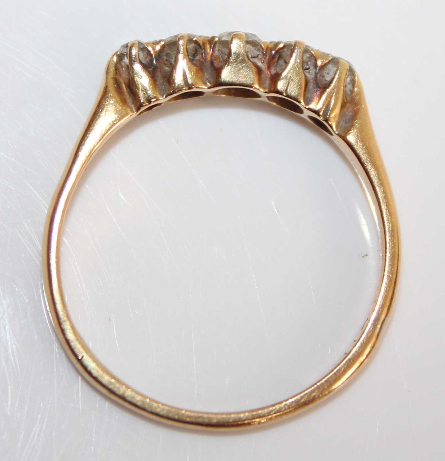 An 18ct gold and platinum diamond half hoop ring, arranged as five claw set graduated round cuts, - Image 6 of 7