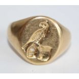 A gent's 18ct gold signet ring, the head carved in relief with a bird upon a branch, 13.3g, London