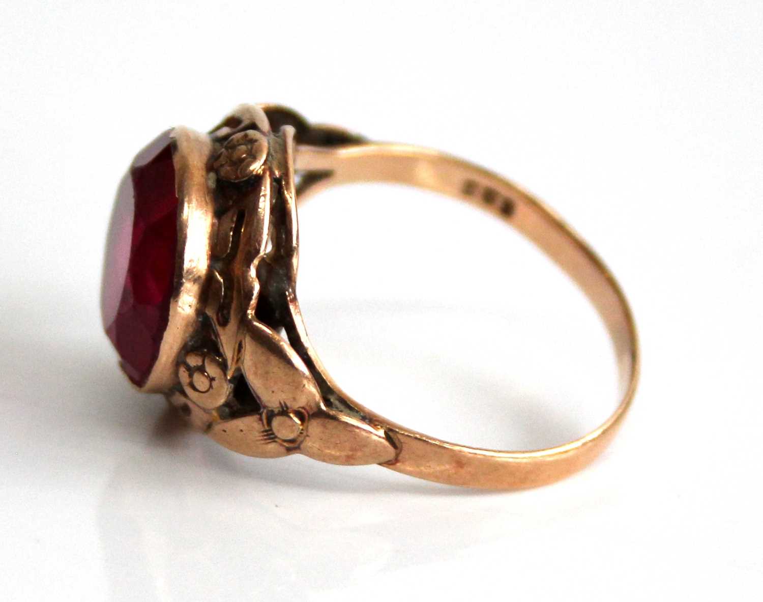 A yellow metal and synthetic ruby set dress ring, the large round cut red stone measuring approx - Image 4 of 6