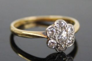 An 18ct gold and platinum diamond flower head cluster ring, arranged as seven pavé set old round