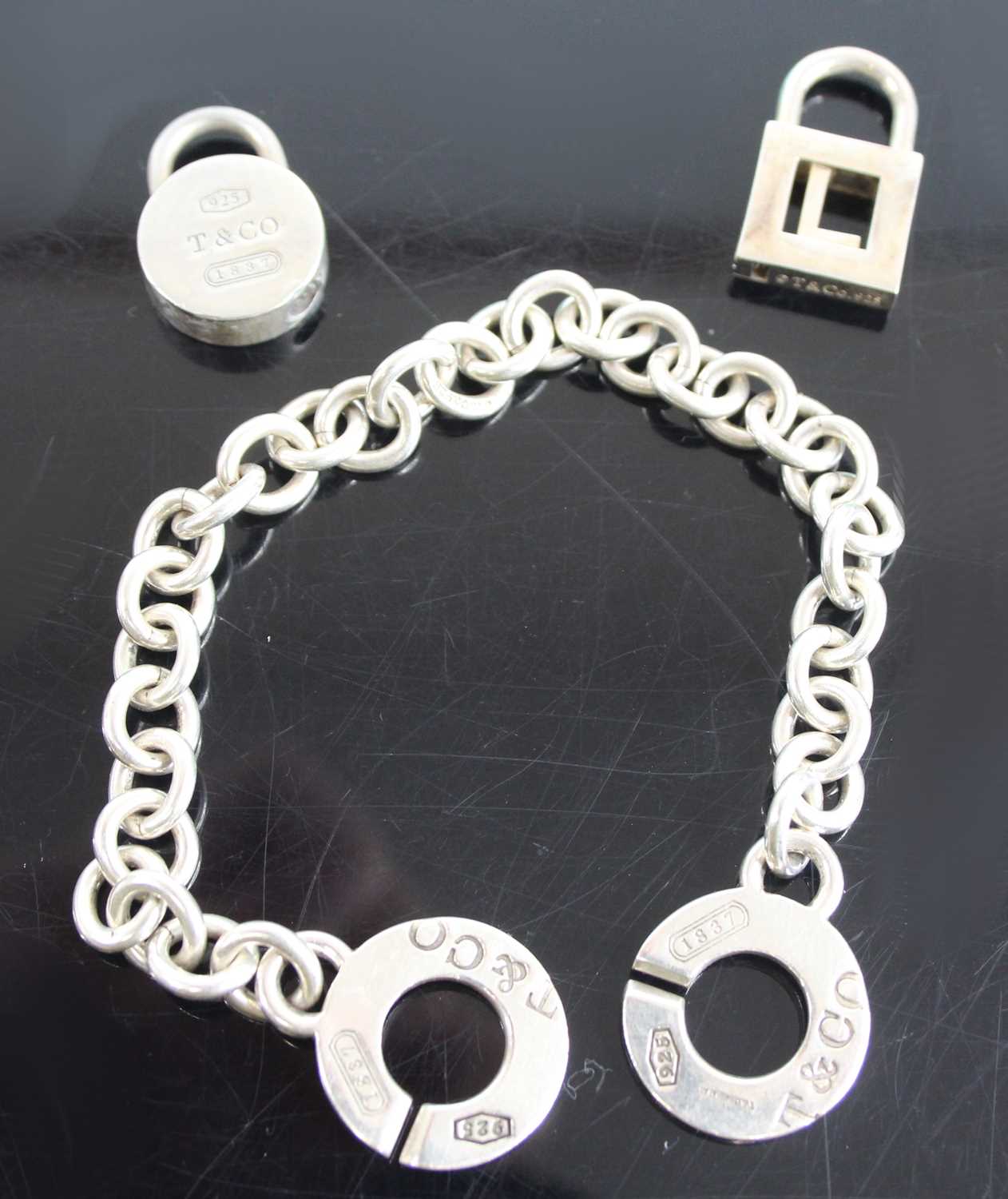 A Tiffany & Co silver bracelet, 19.5cm; together with two Tiffany & Co silver padlock clasps,