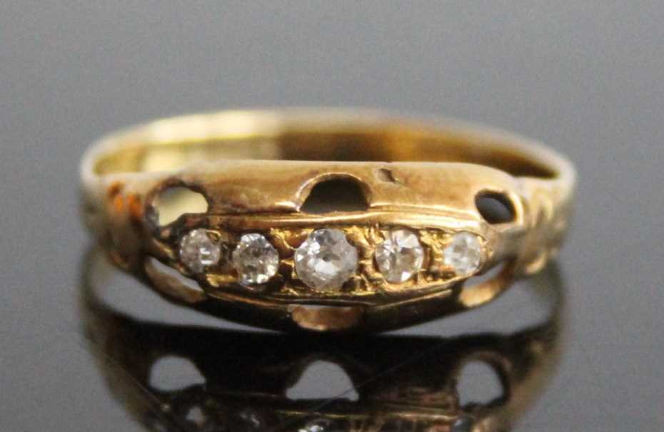 A yellow metal diamond half hoop ring, comprising five graduated Old European cut diamonds in boat