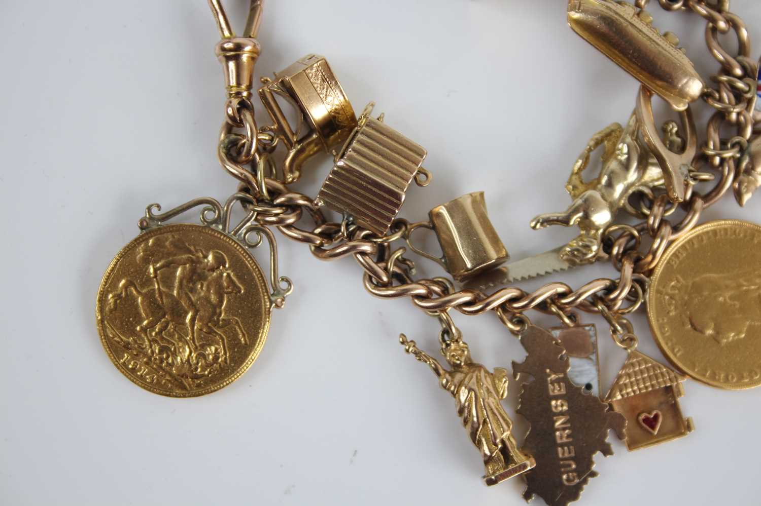 A 9ct gold curblink bracelet containing a collection of charms, principally in 9ct gold and to - Image 5 of 5