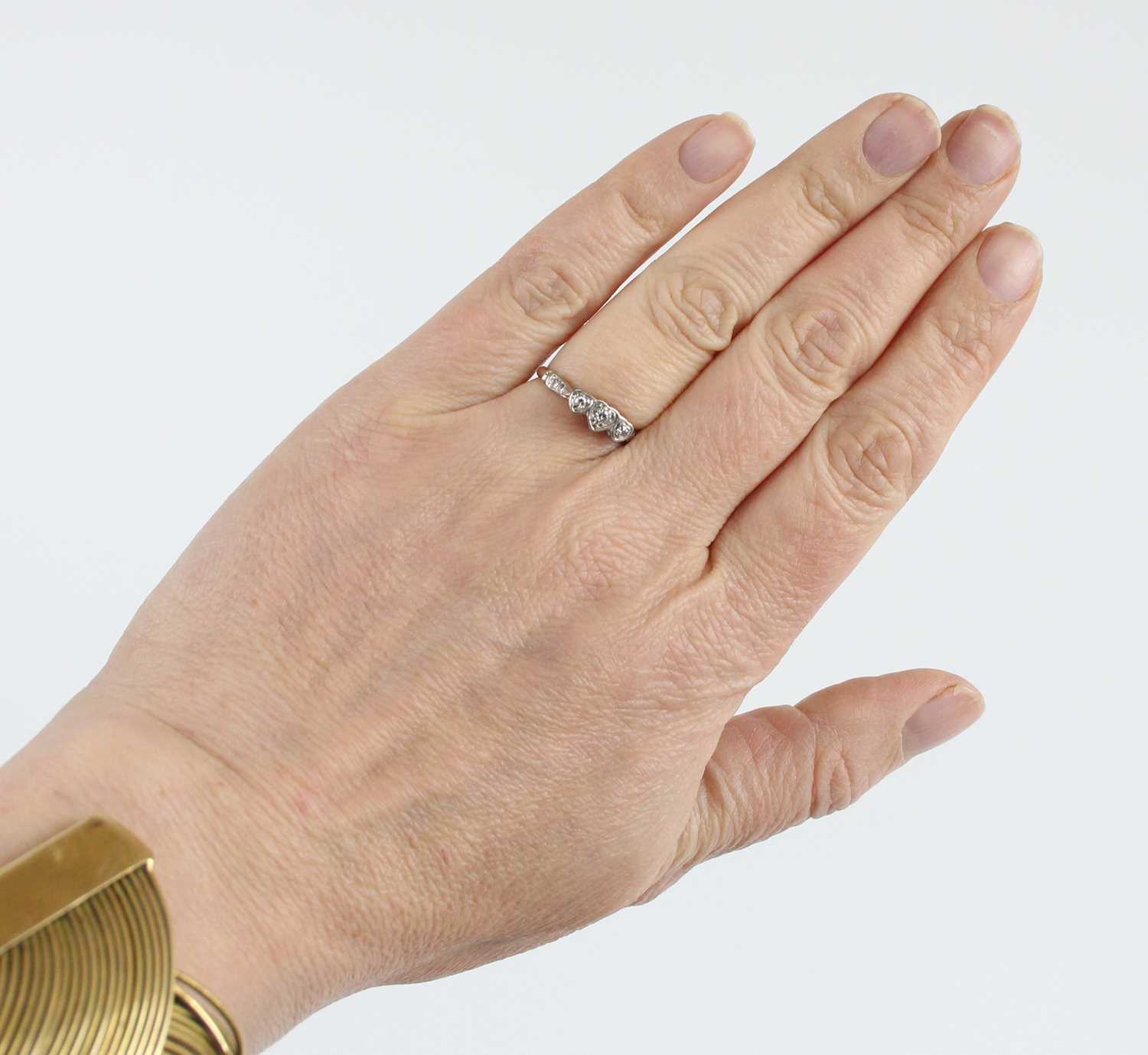 A yellow and white metal diamond three-stone ring, having three single cut diamond in heart shaped - Image 6 of 6