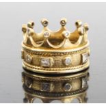 A contemporary Arts & Crafts yellow metal and diamond set ring fashioned as a crown, the 7mm band