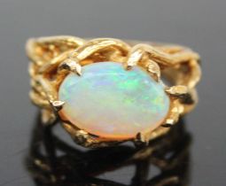 An 18ct gold and cabochon opal set dress ring, the claw set opal measuring approx 12.2 x 8.7 x 3.