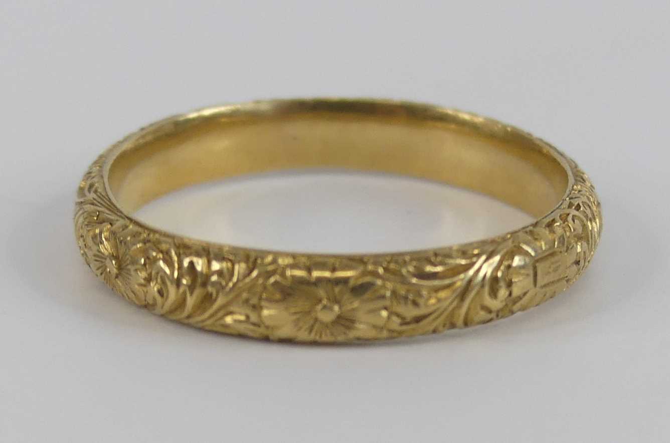 An 18ct yellow gold 3mm engraved band ring, with raised floral detail, size L, gross weight 3g, - Image 3 of 5