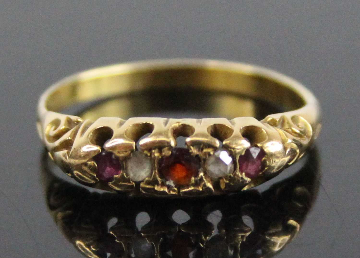 A yellow metal, garnet, diamond and ruby half hoop eternity ring, featuring a centre round garnet - Image 7 of 7