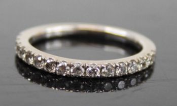 A contemporary 18ct white gold diamond half eternity ring, arranged as sixteen claw set round