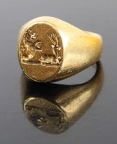 A Kutchinsky 18ct gold signet ring, the head with relief carved armorial, 13.9g, size I, London 1976