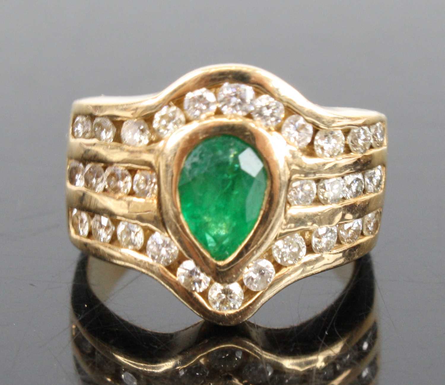 A 14ct yellow gold emerald and diamond dress ring, featuring a centre pear cut emerald in a bezel - Image 2 of 4