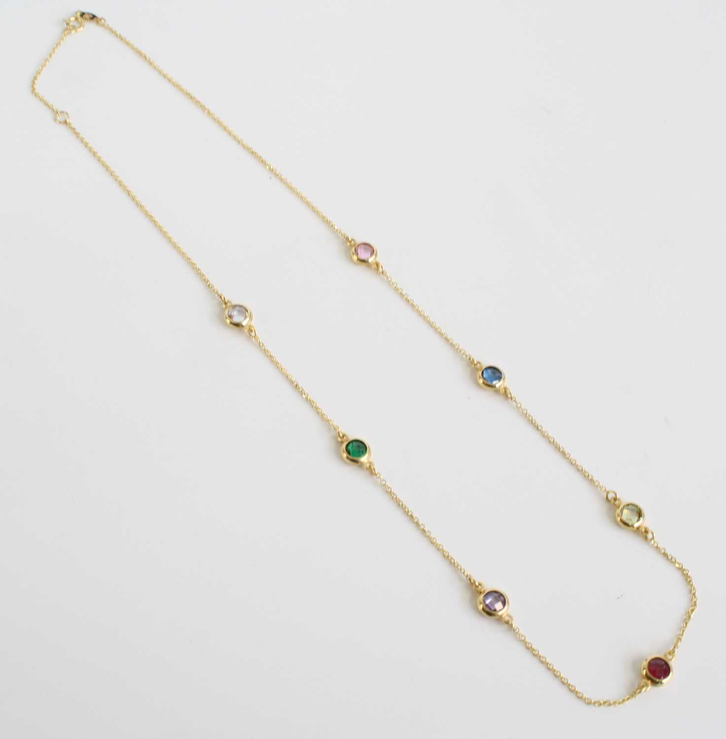 A yellow metal necklace with seven round faceted multi-coloured cubic zirconia in bezel settings, - Image 2 of 3