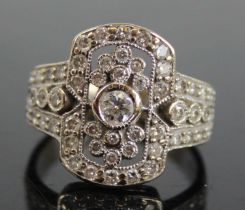 An Art Deco white metal diamond cluster ring, arranged as a centre round cut diamond weighing approx