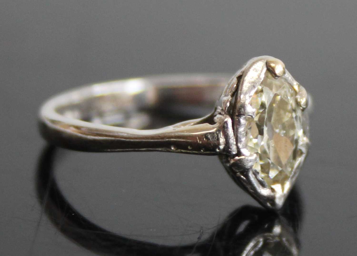 A platinum and diamond single stone ring, the bezel set marquise cut tinted diamond measuring approx - Image 2 of 7