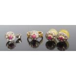 An 18ct gold ruby & diamond garniture comprising ring, pendant and pair of ear studs, each centre