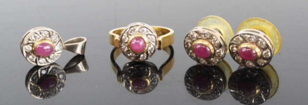 An 18ct gold ruby & diamond garniture comprising ring, pendant and pair of ear studs, each centre
