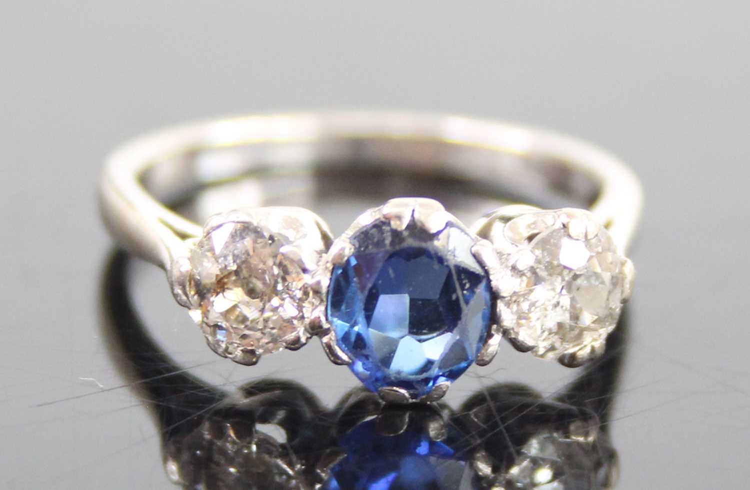 A white metal, sapphire and diamond three-stone ring, featuring a centre oval sapphire with an Old - Image 2 of 7