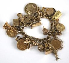 A 9ct gold curblink bracelet containing a large quantity of charms, the charms in unmarked yellow