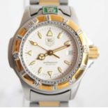 A ladies bi-metal Tag Heuer professional quartz watch with round cream baton dial and date at 3,