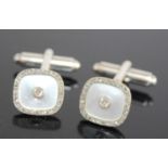 A pair of 9ct yellow and white gold diamond set cufflinks, the shaped square mother of pearl inset