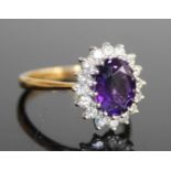 A contemporary 18ct gold, amethyst and diamond flower head cluster ring, the claw set oval cut