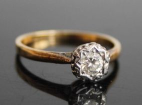 An 18ct gold diamond solitaire ring, the illusion set round cut diamond weighing approx 0.23 carats,