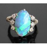 An 18ct white gold, black opal and diamond dress ring, having a centre oval cabochon opal flanked to