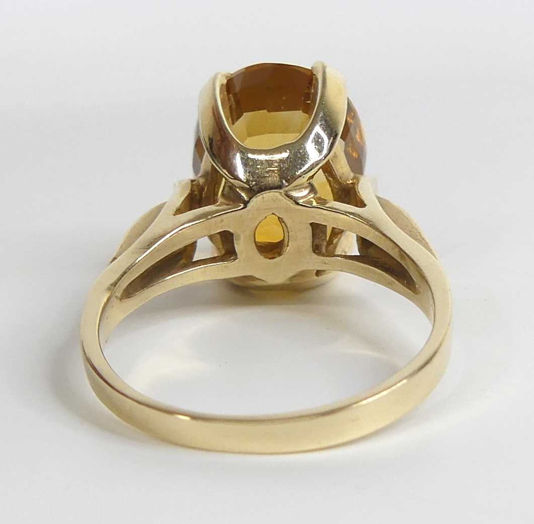 A yellow metal citrine single stone ring, featuring an oval citrine in a four-claw setting with - Image 4 of 7