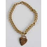 A yellow metal heavy curblink bracelet, having heart shaped pendant with engraved presentation