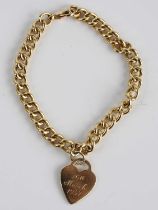 A yellow metal heavy curblink bracelet, having heart shaped pendant with engraved presentation
