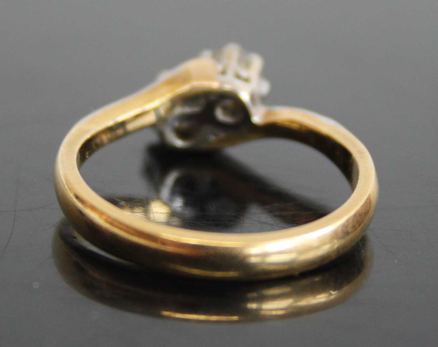 An 18ct gold diamond crossover ring, arranged as two claw set round cut diamonds, total diamond - Image 3 of 6