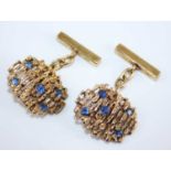 A cased pair of modern 9ct gold sapphire set cufflinks, of abstract design, each set with five round