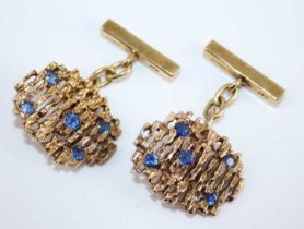 A cased pair of modern 9ct gold sapphire set cufflinks, of abstract design, each set with five round
