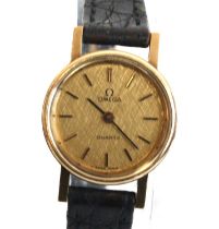 A lady's 9ct gold cased Omega quartz wrist watch with round champagne baton dial fitted to a black