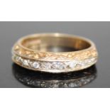 A 9ct gold diamond half eternity ring, arranged as nine small round cuts in a carved setting,