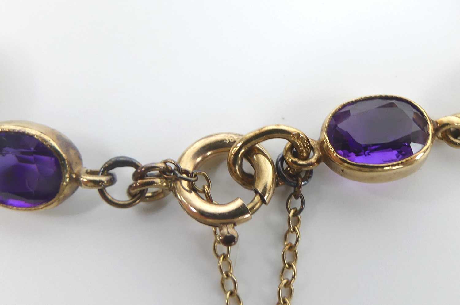 A 9ct yellow gold amethyst bracelet, featuring seven oval amethysts alternating with open oval - Image 4 of 4