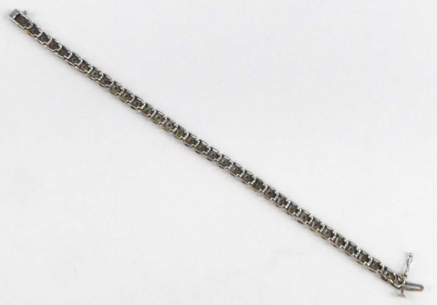 A 9ct white gold diamond tennis style bracelet, having box clasp and figure-of-eight safety catch, - Image 4 of 5