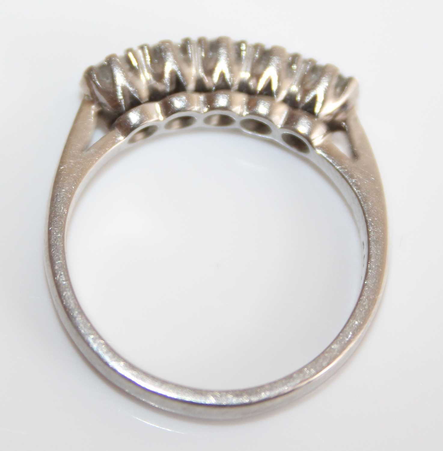 A platinum diamond half hoop ring, arranged as five claw set brilliants in a line setting, total - Image 5 of 5