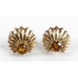 A pair of yellow metal citrine sunburst design stud earrings, each featuring a round citrine in a